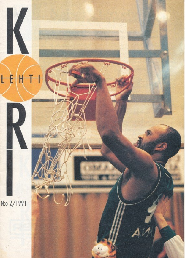 Ein Mann in einem Basketballtrikot dunkt einen Ball in einen Korb mit einem Netz im Hintergrund, während eine andere Person in der Nähe an einer Wand steht. Text auf der linken Seite lautet "Kobe Bryant 1991-92 Basketballkarte."