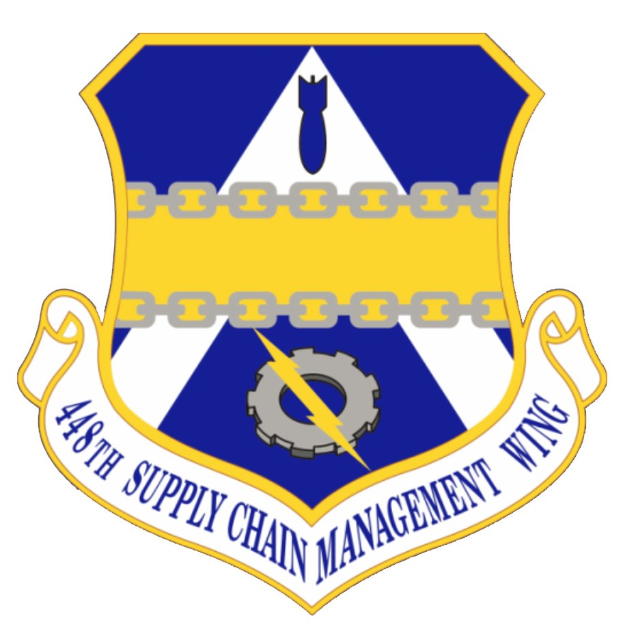 Logo des 48. Versorgungsgeschwader mit einem blauen Schild mit einem weißen Stern und einem weißen Banner mit der Aufschrift "Versorgungsgeschwader" in blau, alles von einem weißen Rand mit der schwarzen Schrift "48. Versorgungsgeschwader" umgeben.